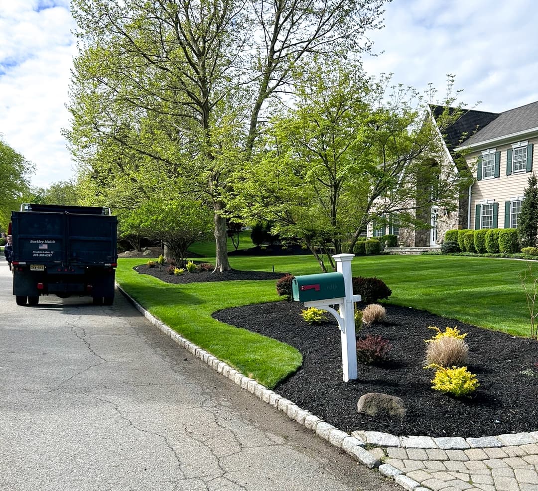 Barkley truck delivering fresh mulch on site